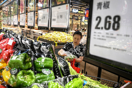 スーパーの野菜売り場で買い物する人＝７月１０日、中国・河北省（ＡＦＰ時事）