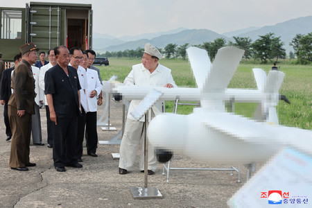 ２４日、攻撃型無人機を視察する金正恩朝鮮労働党総書記（配信元の朝鮮中央通信による画像処理があります）（朝鮮通信・時事）