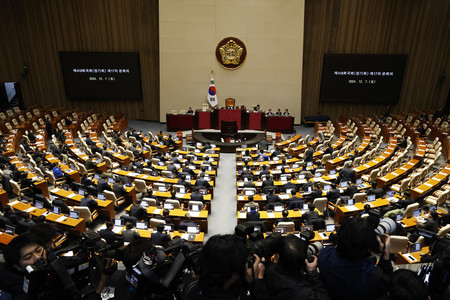7日、韓国・ソウルで開かれた国会本会議で、尹錫悦大統領の弾劾訴追案採決に臨む議員ら(EPA時事)