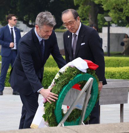 平和記念公園内の原爆死没者慰霊碑に献花するデンマークのフレデリック国王=25日午前、広島市中区
