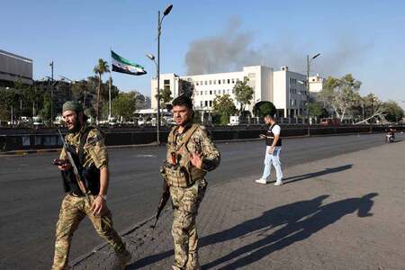 １６日、イスラエル軍の攻撃を受け、ダマスカスの軍施設を警備するシリア治安部隊（ＡＦＰ時事）