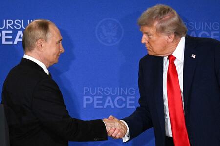 8月15日、米アラスカ州アンカレジで握手するトランプ米大統領(右)とロシアのプーチン大統領(AFP時事)